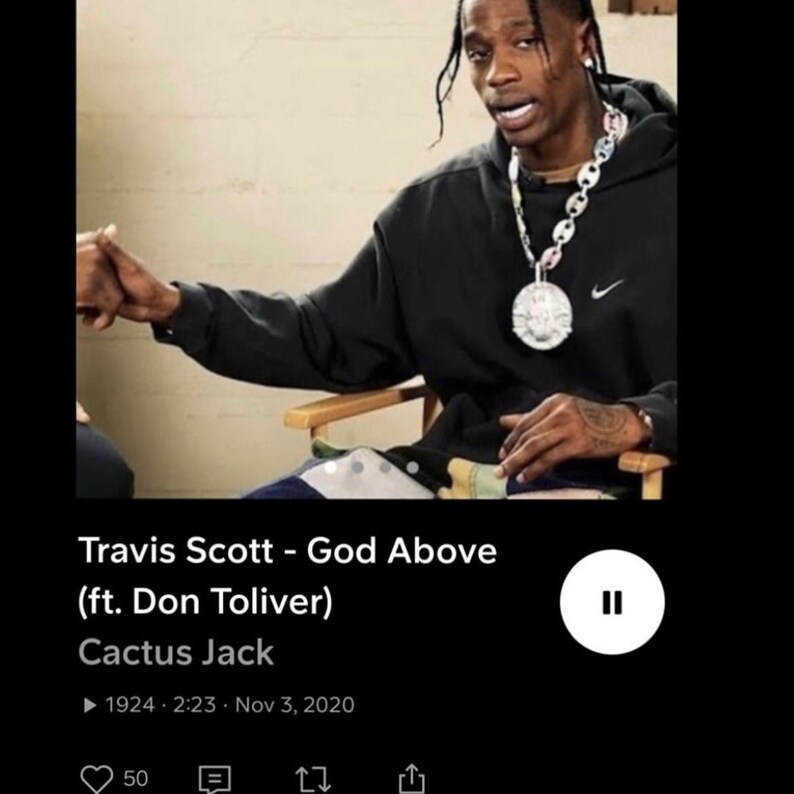 May include: Image of Travis Scott wearing a black hoodie with a Nike logo, a large silver chain, and a pendant. The image includes text that reads "Travis Scott - God Above (ft. Don Toliver)" and "Cactus Jack."