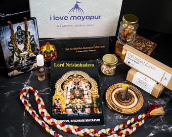 May include: A gift box filled with items for a spiritual practice. The box includes a book titled "Lord Nrisimhadeva", a small framed image of a deity, a bottle of oil, a string of beads, incense sticks, a wooden incense burner, a small bag of dried fruit, and a small book titled "Śri Nrsimha-Kavaca-Stotram & Some Other Prayers".