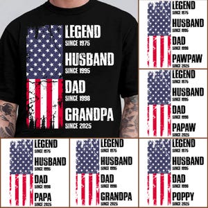 May include: Black t-shirt featuring a distressed American flag design. The shirt includes the words "LEGEND SINCE 1975, HUSBAND SINCE 1995, DAD SINCE 1998, GRANDPA SINCE 2025" in white text. Additional shirts with similar designs are also shown.