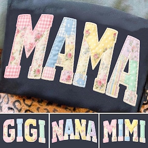 May include: A dark blue fabric with the word "MAMA" in large, patchwork letters. Each letter is made of different floral and patterned fabrics, including gingham and polka dots. Below are the words "GIGI", "NANA", and "MIMI" in a similar style.