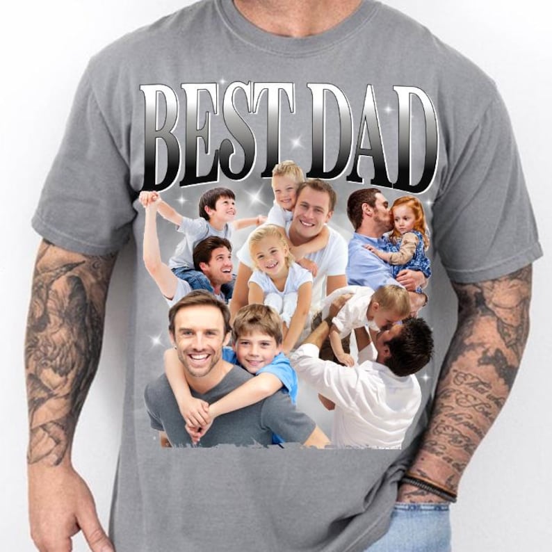 May include: Gray t-shirt with the text "BEST DAD" in a silver gradient font. The shirt features a collage of photos of fathers with their children. The overall theme is family and fatherhood.