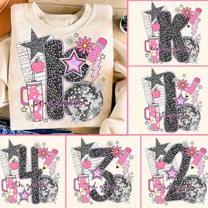 May include: Cream-colored sweatshirt with a colorful school-themed design. The design includes a large letter, a disco ball, stars, a pencil, and a drink cup. The sweatshirt has the word "Preschool" printed on it.