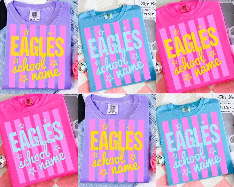 May include: A collection of six t-shirts in various colors, including purple, blue, and pink. Each shirt features the word "EAGLES" in large letters, along with "school name" and star graphics, all set against a striped background.