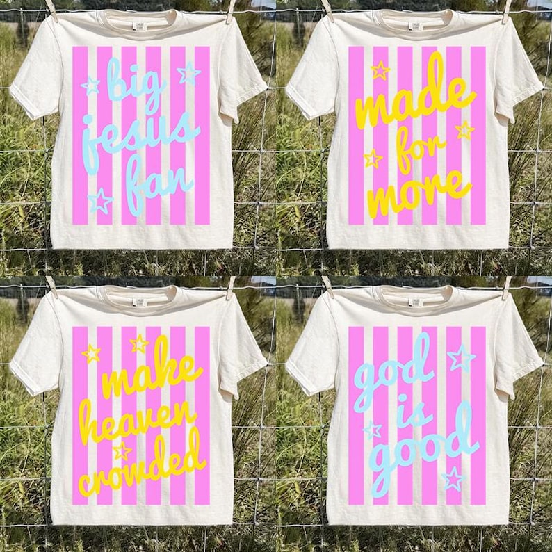 May include: Four off-white t-shirts with different phrases in colorful text. Each shirt has a pink striped background. The phrases are: "big jesus fan", "made for more", "make heaven crowded", and "god is good".