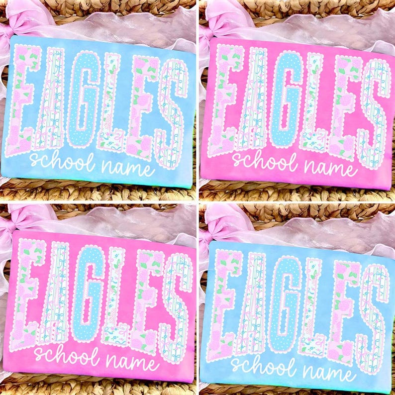 May include: Four t-shirts with the word "EAGLES" in large, decorative letters. The shirts are in shades of pink and blue, with the text in contrasting colors and a floral pattern. The words "school name" are below the main text.