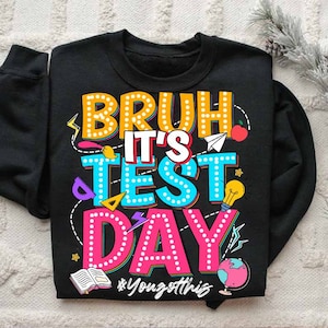 May include: Black sweatshirt with a colorful graphic design that says "Bruh it's test day" with a hashtag that says "#Yougotthis".