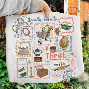 May include: A white tote bag featuring a colorful illustration of various vintage items, including a shopping cart, mirror, owl, and teapot. The words "Literally born to Thrift" are printed on the bag in a whimsical font.