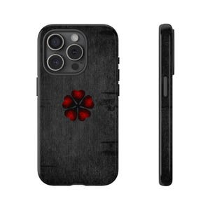 May include: Black phone case with a textured wood-grain design. The case features a red five-leaf clover emblem. The phone case is shown from the front and side, highlighting the camera and side buttons.