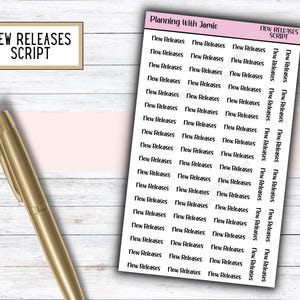 May include: A sheet of white planner stickers featuring the black text New Releases in a script font, arranged in multiple columns. The top of the sheet is labeled Planning With Jamie and New Releases Script. A gold metallic pen is positioned nearby.
