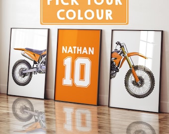 May include: Three framed prints featuring motocross bikes and a jersey design. The jersey print is orange with the name "NATHAN" and the number "10" in white. The other two prints show orange and black dirt bikes. The top sign says "PICK YOUR COLOUR".