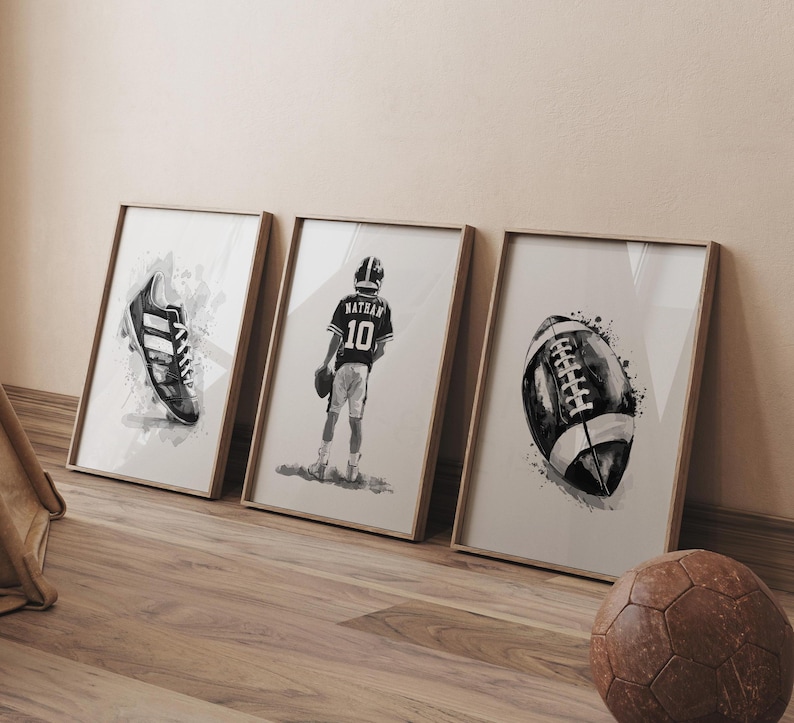 May include: Three black and white watercolor prints in frames. The prints feature a football, a football player, and a football cleat.