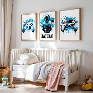 May include: Three framed prints with a blue and white color scheme. The prints feature a gamer with headphones, a video game controller, and the name "NATHAN".