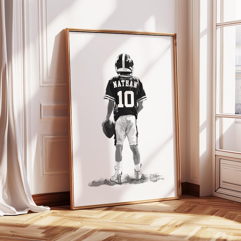 May include: Black and white illustration of a young person wearing a football uniform with the name "Nathan" and the number "10" on the back. The person is holding a football and standing on a white background.