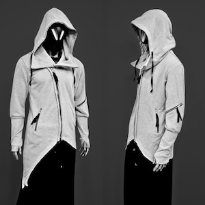 May include: A gray hooded sweatshirt with a zipper closure and a long, asymmetrical hemline. The sweatshirt has a relaxed fit and a casual style.