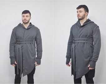 May include: A grey hooded sweatshirt with a long, asymmetrical hem and a tie belt. The sweatshirt has a relaxed fit and a casual style.