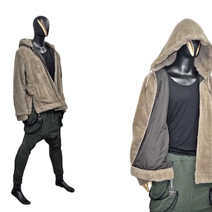 May include: A brown hooded jacket with a zipper closure, paired with a black tank top and dark green cargo pants. The jacket has a soft, textured appearance. The pants have multiple pockets and a unique design.