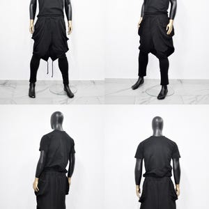 以下が含まれることがあります： マネキンの黒い衣装の4つのビュー。衣装には、半袖Tシャツ、大きなポケットが付いたドロップクロッチパンツ、ぴったりとしたレギンスが含まれます。マネキンは黒い頭と金色の手を持っています。