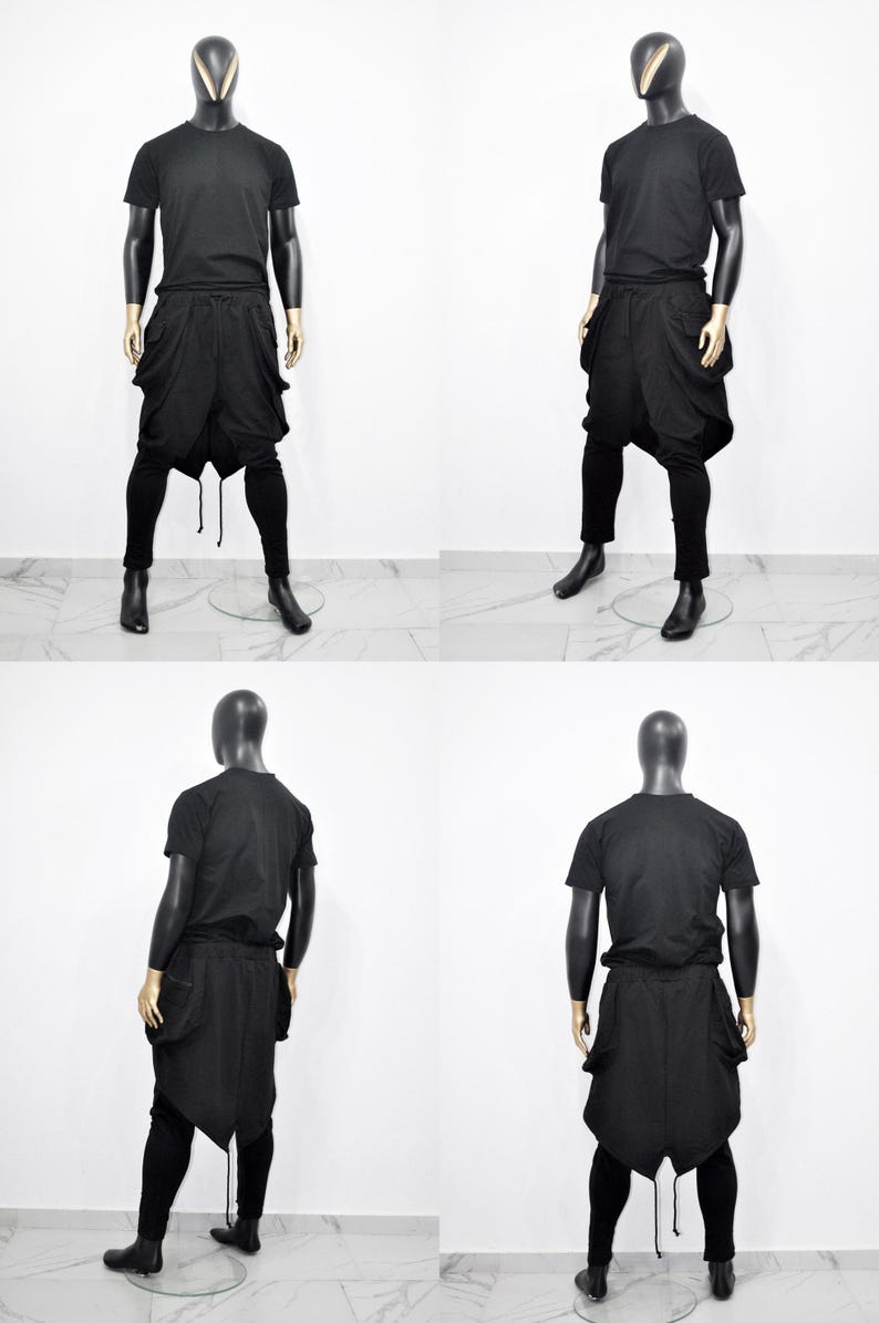 以下が含まれることがあります： マネキンの黒い衣装の4つのビュー。衣装には、半袖Tシャツ、大きなポケットが付いたドロップクロッチパンツ、ぴったりとしたレギンスが含まれます。マネキンは黒い頭と金色の手を持っています。