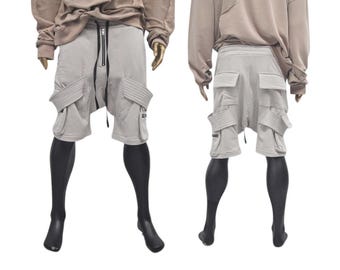May include: Gray cargo shorts with multiple pockets and a zipper fly. The shorts have a relaxed fit and are made of a soft, comfortable fabric.