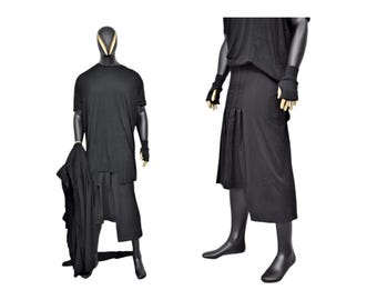 May include: A black long-sleeved shirt with a black skirt. The skirt has a pleated design and is shorter at the front than at the back.