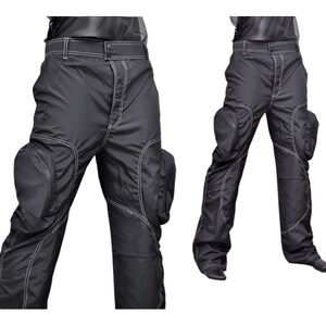 May include: Black cargo pants with white stitching and large pockets on the thighs.