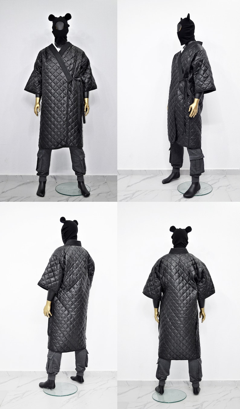 May include: A black quilted robe with a hood and ear flaps. The robe has a tie belt and is worn over grey pants.