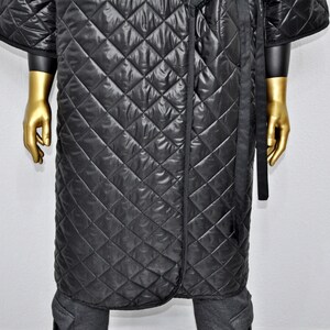 May include: A black quilted robe with a long, black sash. The robe has a diamond pattern and is made of a soft, comfortable material.