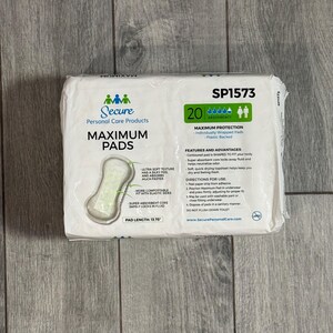 May include: A packet of Secure Maximum Pads, containing 20 individually wrapped pads with a plastic backing. The packaging shows product information, including a pad length of 34.93 cm, and usage instructions.