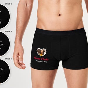 May include: Black boxer shorts with customisable text and image options. One style displays a photo in a heart with "Sweet Cheeks" and "Property of Amy". Other styles include text such as "I licked it", "Property of", and "Best Tinder Match Ever".