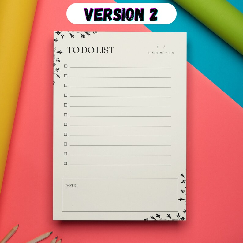 May include: A white to-do list notepad with a floral design border. The notepad has a section for notes and a calendar section with the days of the week abbreviated as S, M, T, W, T, F, S.