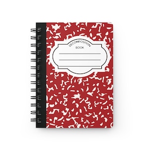 May include: Red composition notebook with a black spiral binding and a white label that says "Decomposition Book".