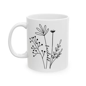 May include: White ceramic mug with a black line drawing of flowers and the word "wildflower" on the side.