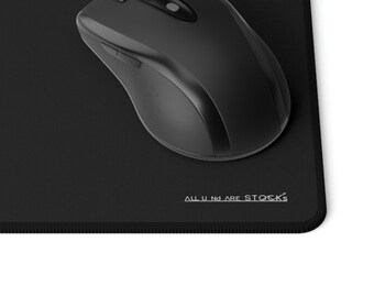 May include: A black mouse mat with a black wireless mouse on top. The mouse mat has a textured surface and the text "ALL IN ARE STOCKS" printed in white on the bottom right corner.