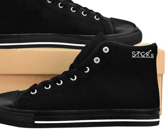 May include: A pair of black high-top canvas trainers with white trim and the word "STCKS" printed on the side.