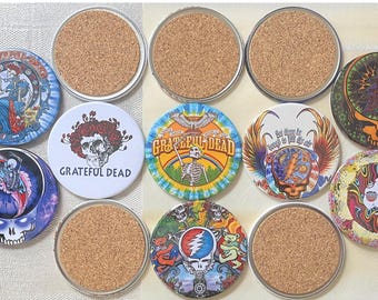 May include: A collection of round coasters with various designs, including the Grateful Dead logo and other psychedelic imagery. The coasters have a cork base and metal rims, with colorful graphics. The coasters are approximately 4 inches in diameter.