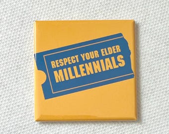 May include: Square yellow button with a blue rectangle design. The blue rectangle contains the text "RESPECT YOUR ELDER MILLENNIALS" in white, bold font. The button has a glossy finish and is set against a white, textured background.