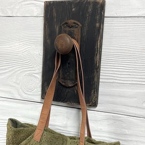 May include: A white ceramic mug with a black handle and the text "But First, Coffee" in a black, bold font. The mug is sitting on a white surface.