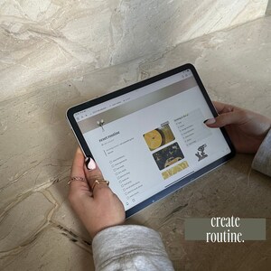 May include: A close-up of a tablet screen displaying a checklist titled "reset routine" with items like "clean bathroom", "dust apartment", "eat meal", "grocery shop", "do laundry", "answer emails", "plan for work ahead", "water plants", and "relax/game".