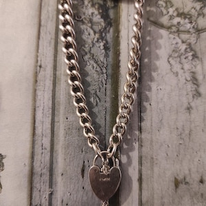 Vintage Bracelet, with heart padlock closure and safety chain,over 23g in weight . Lion Passat mark on graduating links.
