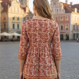 Women wearing a cotton printed kurti with floral ethnic design, featuring 34 sleeves and a comfortable relaxed fit. Lightweight breathable cotton fabric ideal for summer wear, casual outings, office wear, and daily use. Stylish Indian ethnic tunic paired with leggings, perfect for modern women who love traditional fashion.
Cotton printed women’s kurti with floral ethnic design, soft breathable fabric, 3/4 sleeves, comfortable fit. Ideal for casual wear, office use, summer styling,