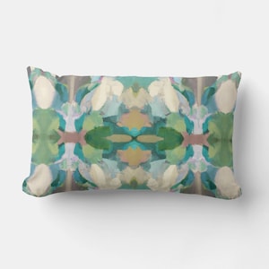 May include: A decorative throw pillow with an abstract design featuring shades of blue, green, white, and pink. The pattern is symmetrical and resembles a kaleidoscope.