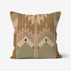 May include: Square decorative pillow with a geometric pattern in shades of brown, beige, and green. The design features repeating shapes and a textured appearance, suitable for home decor.