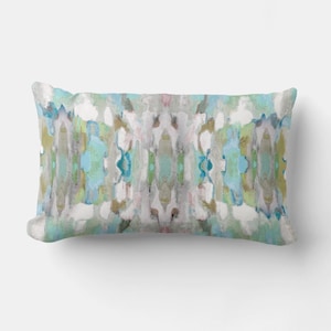 May include: A rectangular throw pillow with a blue, green, and brown abstract pattern. The pattern is symmetrical and features a watercolor-like effect.