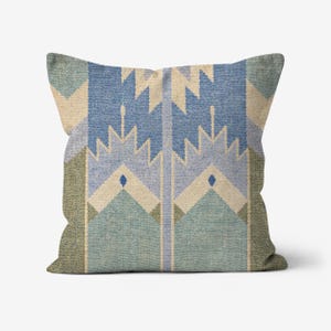 May include: Square throw pillow with a geometric pattern in shades of blue, beige, and green. The design features repeating shapes and lines, creating a textured appearance. The pillow has a neutral background.