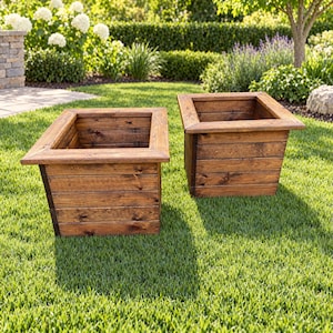 May include: Two square planters constructed from horizontal dark brown stained wooden planks. Each planter features a wide, flat rim around the top opening and a tapered body design, showcasing the natural wood grain texture throughout the exterior.