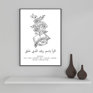 May include: Black and white illustration of a book with flowers on top. The text "Read in the name of your Lord who created" is below the image.