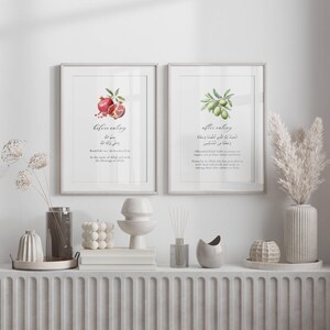 May include: Two framed prints with watercolor illustrations of a pomegranate and an olive branch. The prints have Arabic text and English translations that say "before eating" and "after eating".