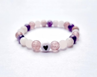Children's bracelet with amethyst, rose quartz, and matte strawberry quartz with natural stones and a heart design.