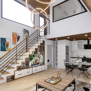 May include: A modern living room with a white and wood interior. The room features a white couch, a coffee table, a black and white rug, a staircase with a black railing, and a large window. There are several paintings on the wall, and a black and white television is mounted on the wall.