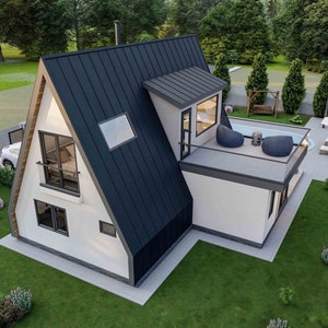 May include: A white and black modern A-frame house with a flat roof and a small deck. The house has large windows and a black metal roof. The house is surrounded by green grass and trees.